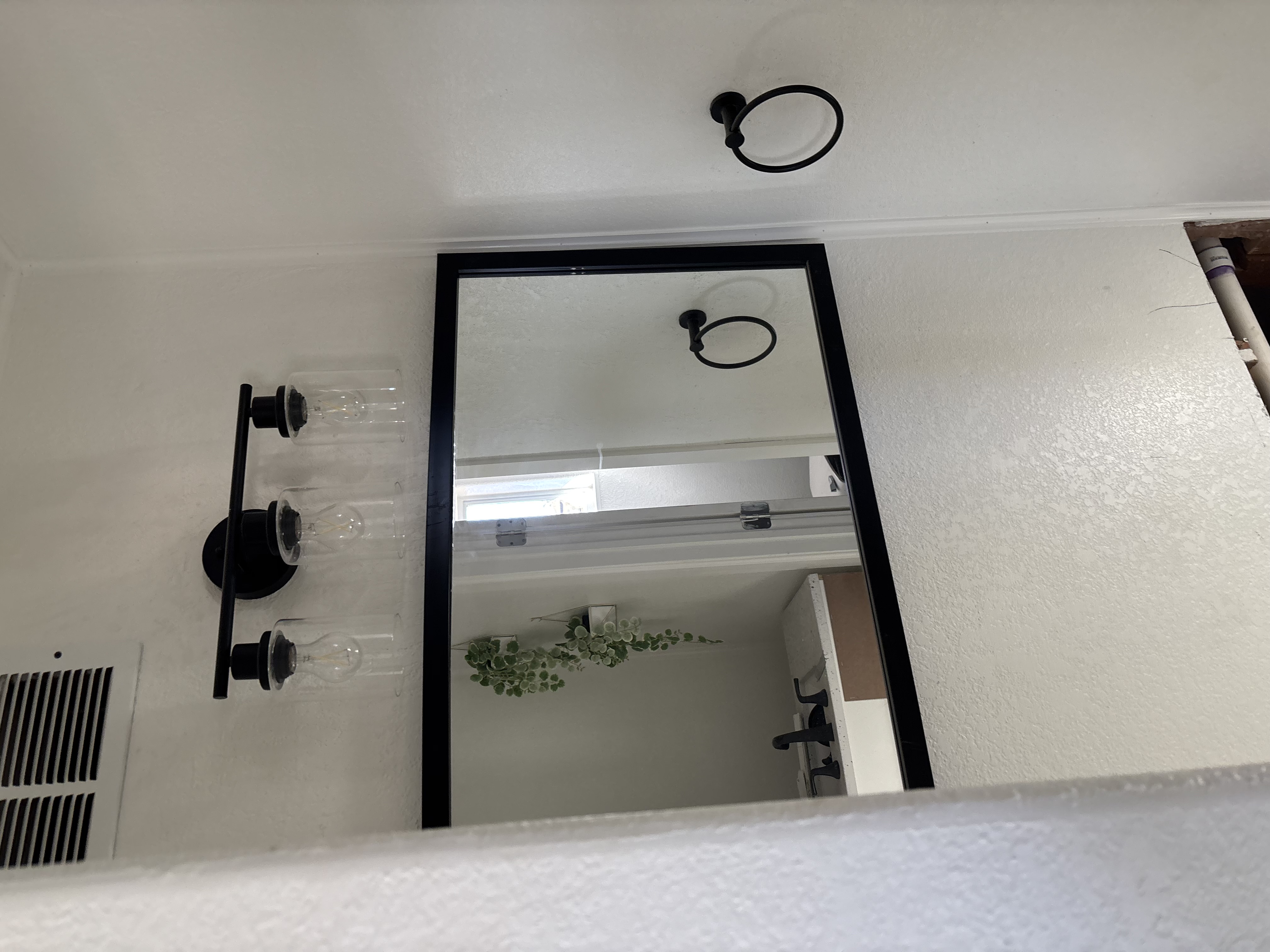 Modern bathroom with black-framed mirror